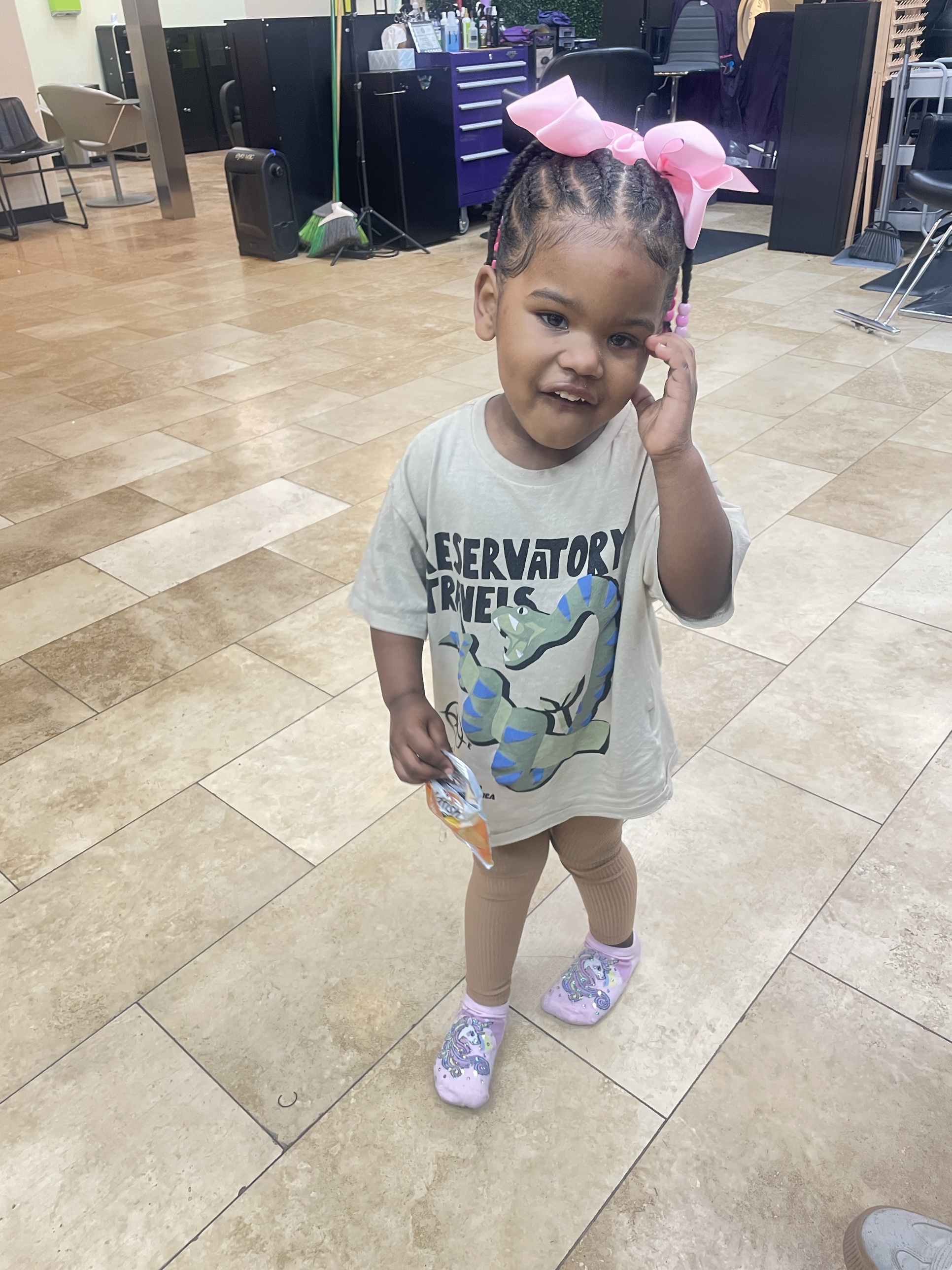 Toddler with braids and pink bows